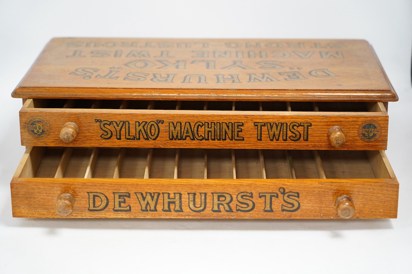 A mid 20th century Dewhurst's Sylko oak two drawer table top retail chest, 51cm wide, 14cm high. Condition - good